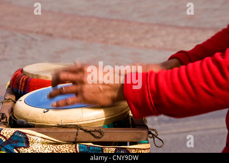 Closeup of an African male drummer`s hands in action beating on Djembe drums while performing live in Dundee,UK Stock Photo